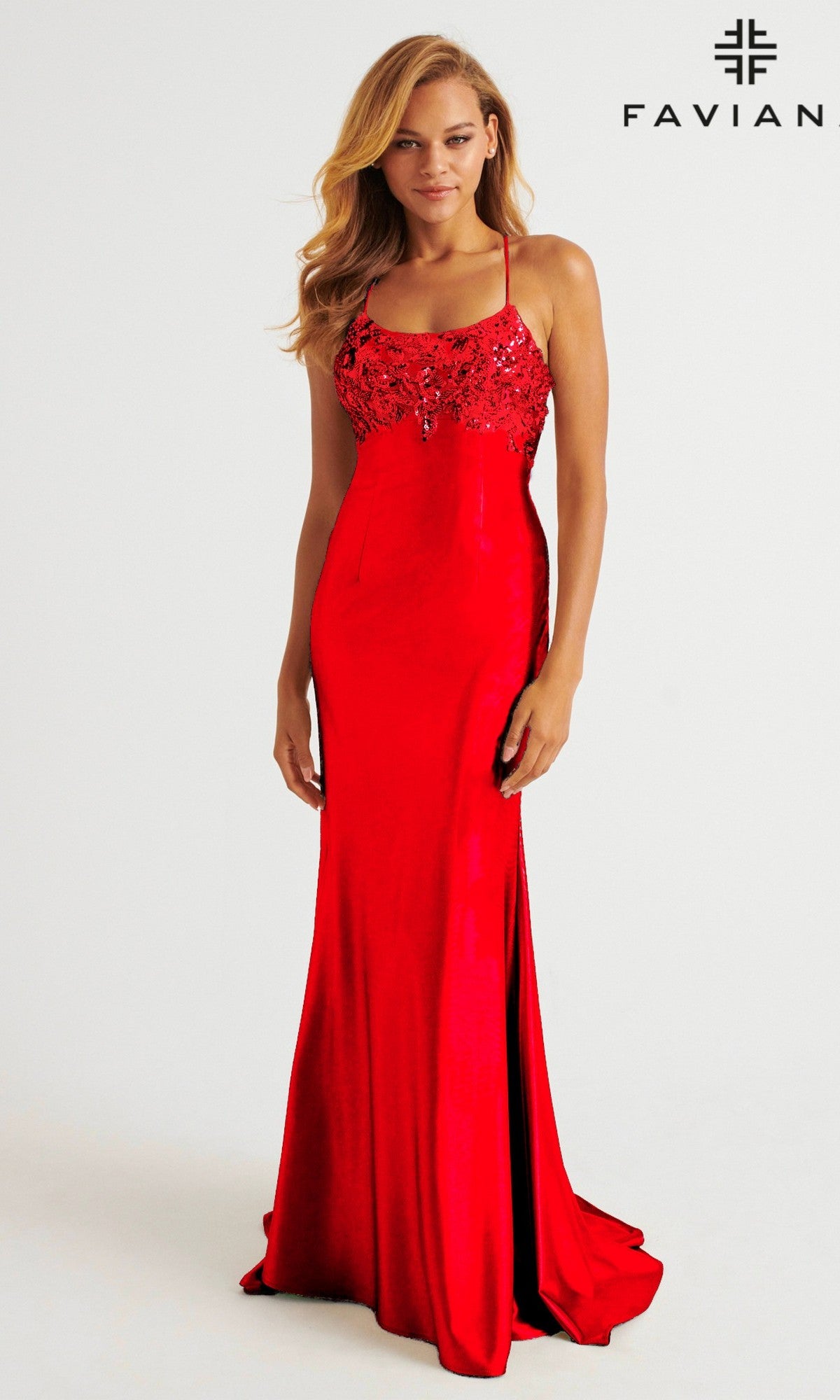 A woman models the Strappy Open-Back Long Prom Dress: Faviana E11201, featuring a beaded bodice, while standing against a plain background with the